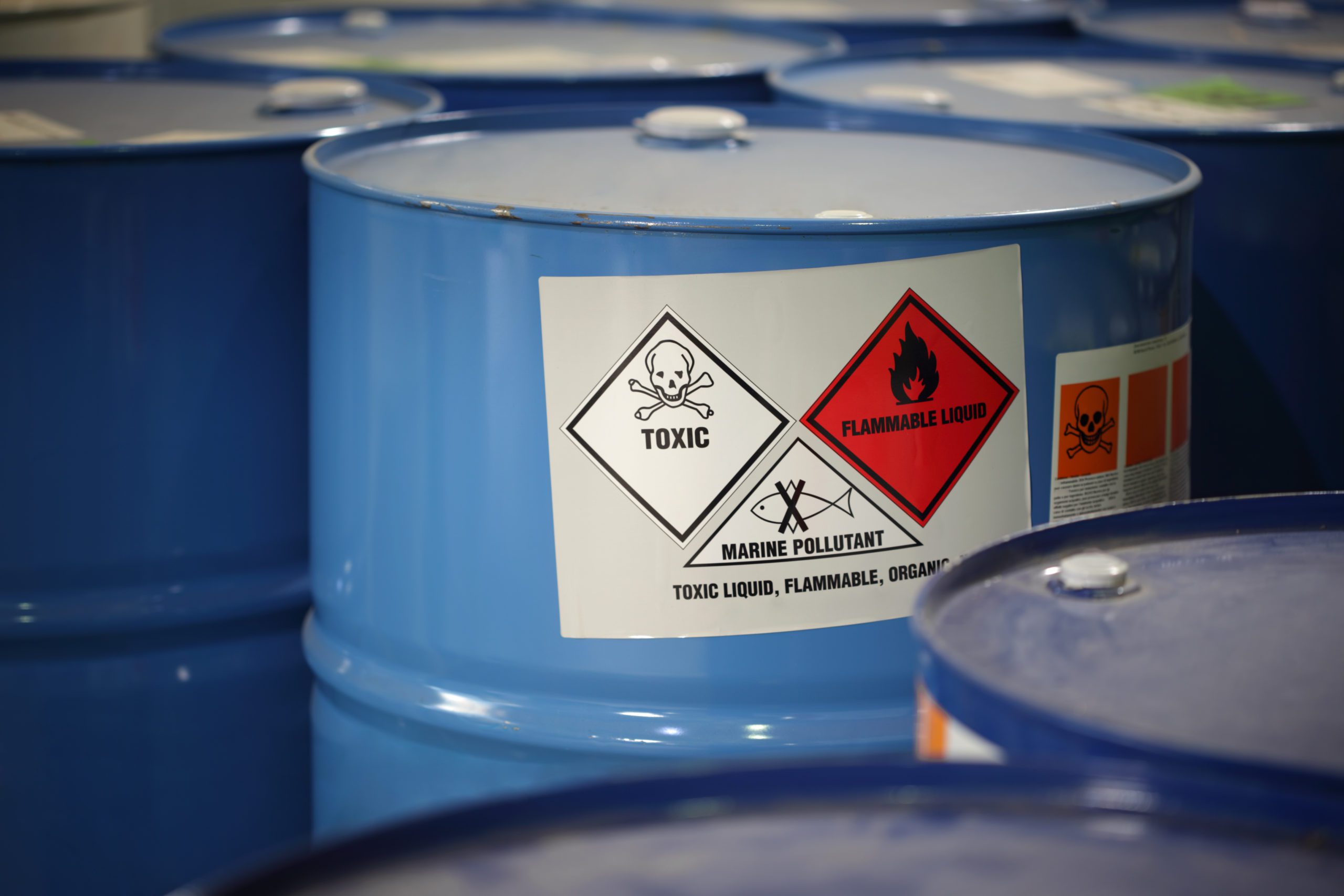 Image of a blue waste bin with toxic substance labels